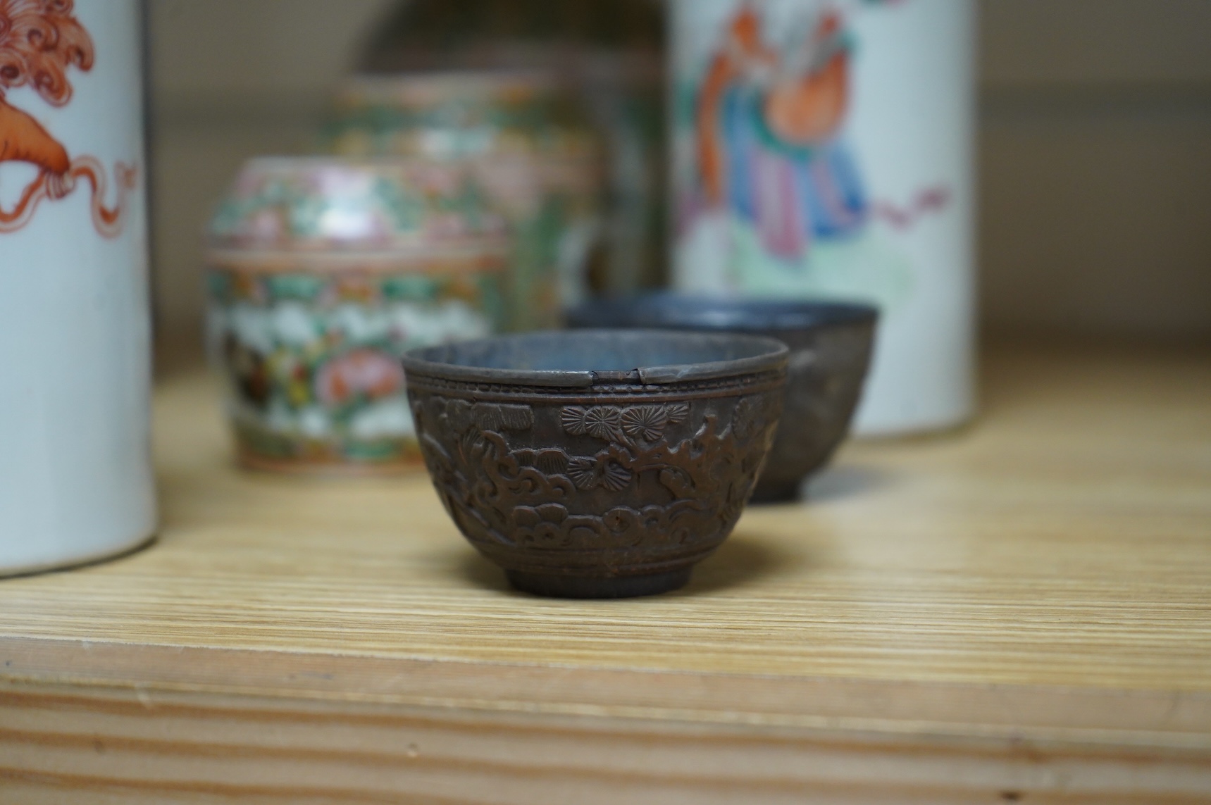 A collection of Chinese ceramics to include a blue and white mug, set of three graduated Canton jars and covers and two cylindrical brush washers